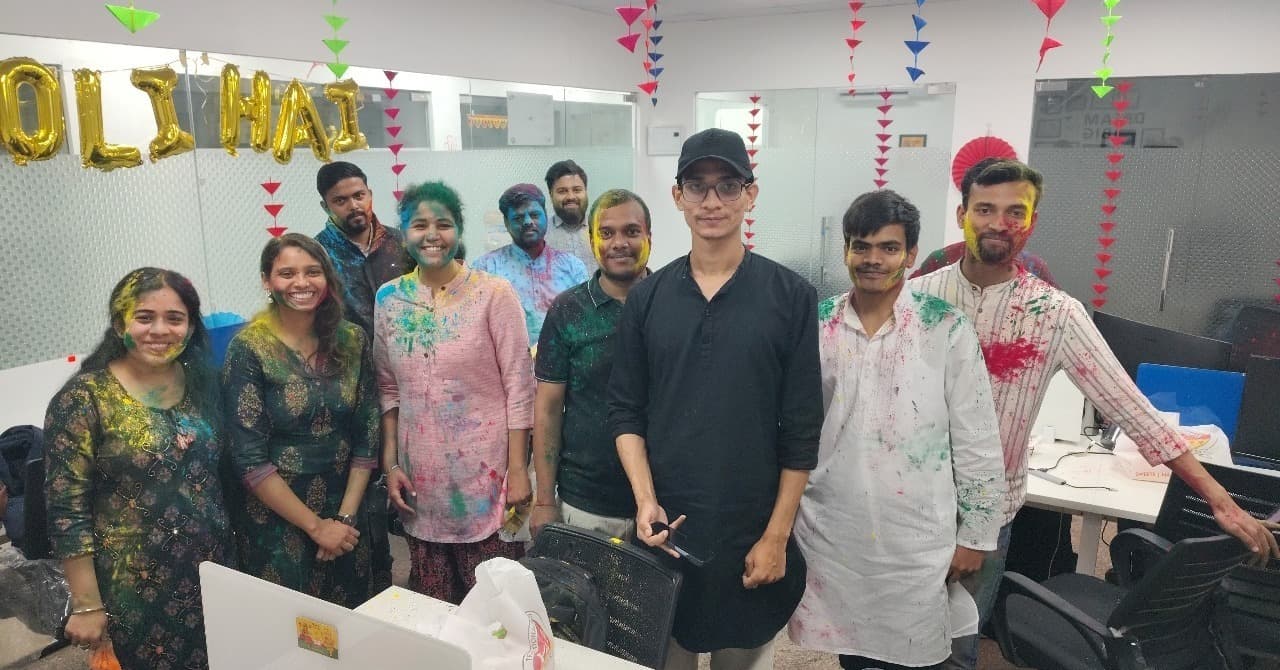 Team covered in Holi gulal in the office
